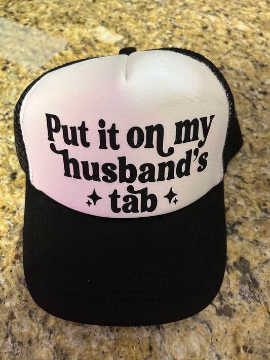 Put It On My Husbands Tab Trucker Hat